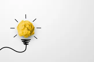 Paper scrap ball yellow colour with light bulb symbol